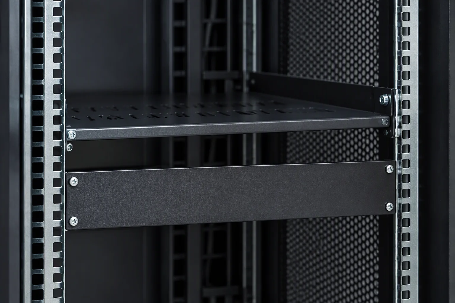 A close crop across the open front of a 42U cabinet: the two 19-inch mounting rails and their repeating U-slot pattern