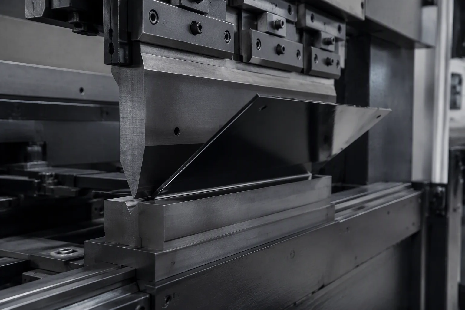 Array of laser-cut and powder-coated sheet metal parts arranged on a workshop bench