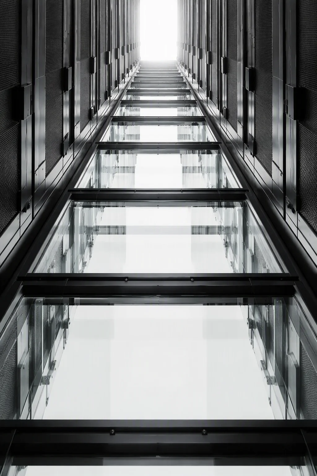 Containment aisle roof seen from below, with steel and glass panels and one drop-away flap hanging open